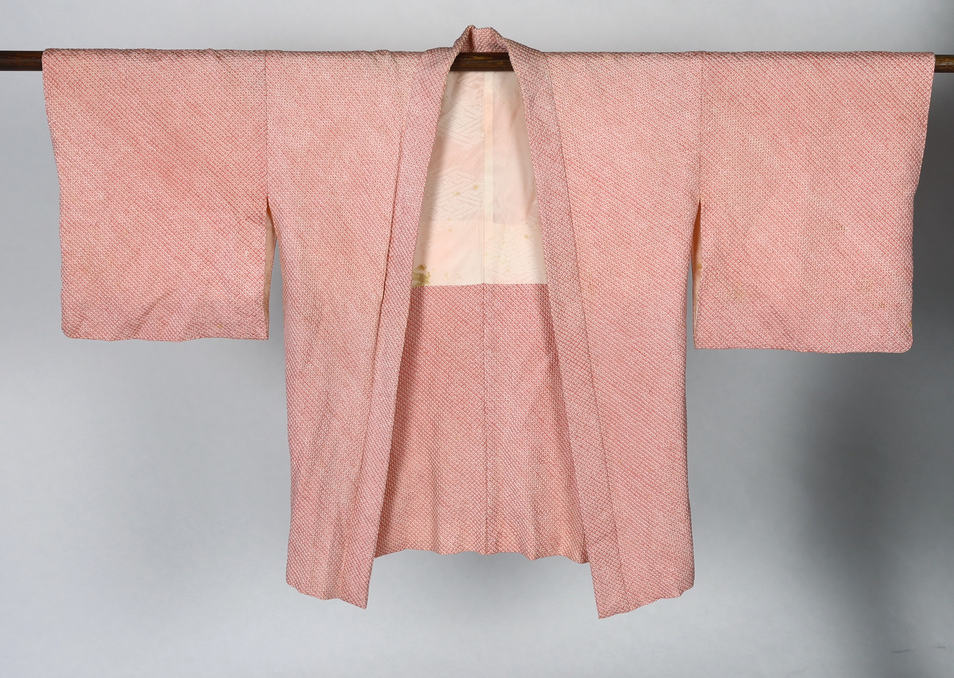 A Japanese Shibori kimono, the silk minutely tie-dyed into a raised spot like design by hand, circa 1920's. This design 'haori himo', lined with a silk damask, 69cm long